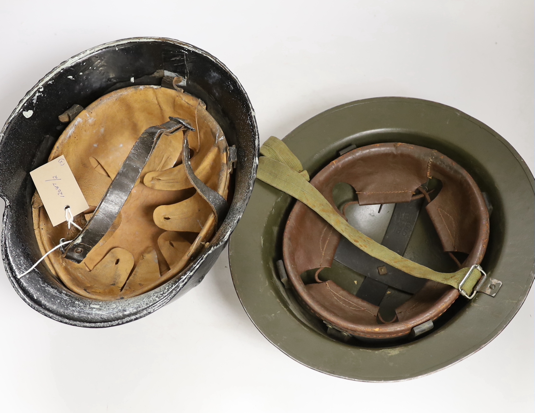 A German WW2 helmet and a British helmet